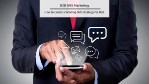 Stock feature image - B2B SMS Marketing - Image shows a man in a suit looking at his cellphone